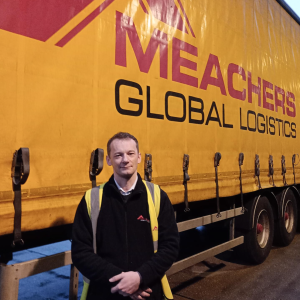Lukasz Czech standing beside a Meachers truck