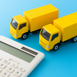 Two yellow trucks facing a calculator